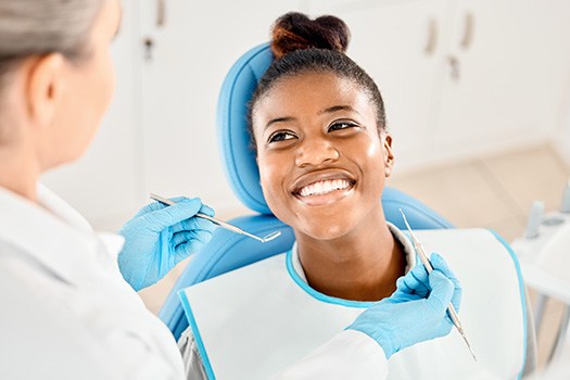 Woman smiling at dentist during exam