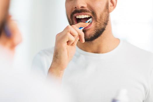 Closeup of man brushing his teeth