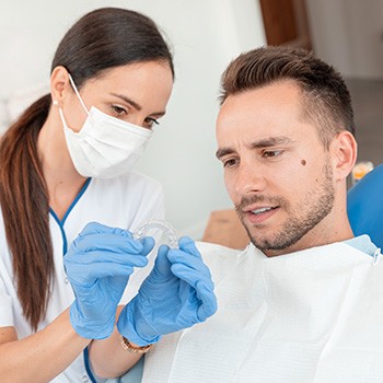 Dentist providing patient with his clear aligners