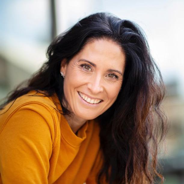 Woman smiling with new dental veneers