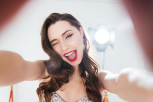 Woman smiling with a spotlight behind her